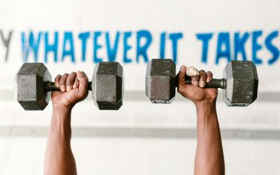 Close-up of a hand gripping a dumbbell firmly.